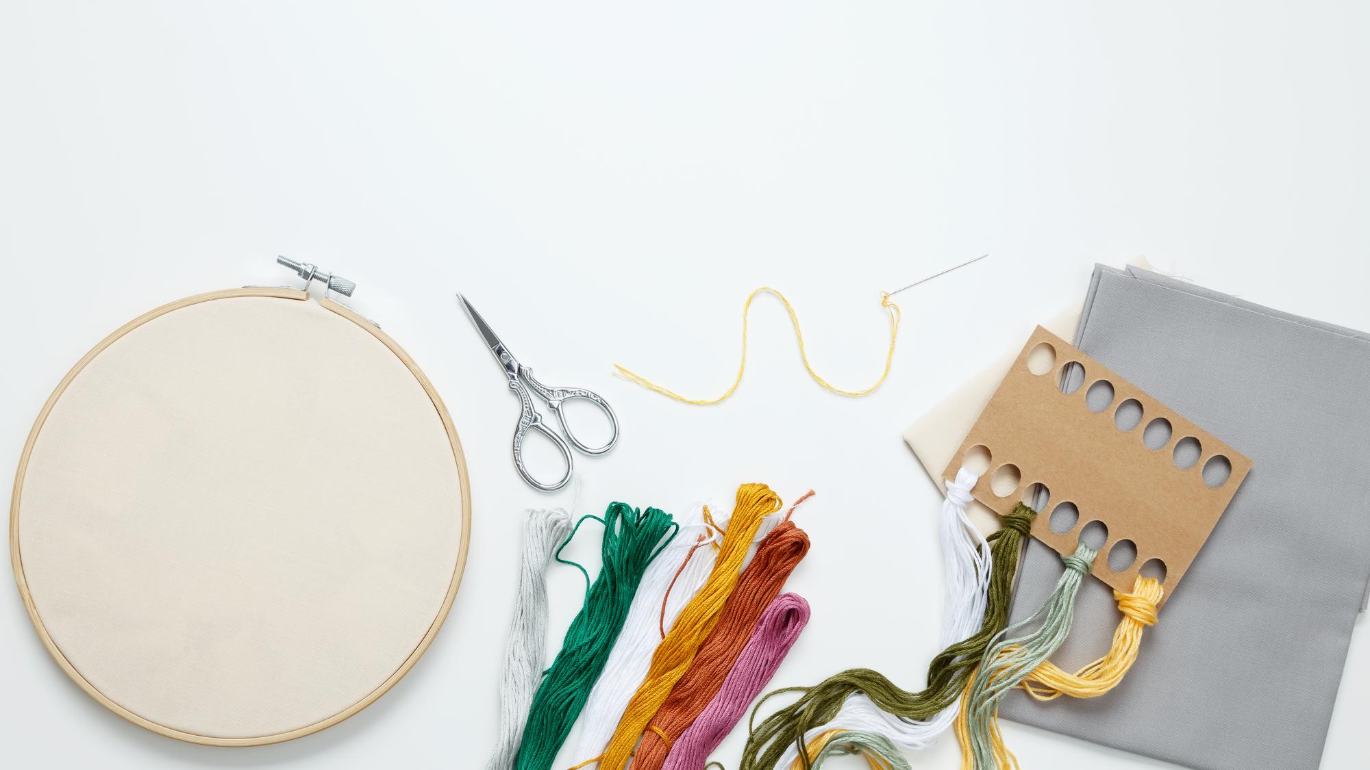 flatlay of embroidered goods and tools